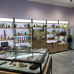 A wall displaying products and accessories at Purple Moose Cannabis Lawrence location